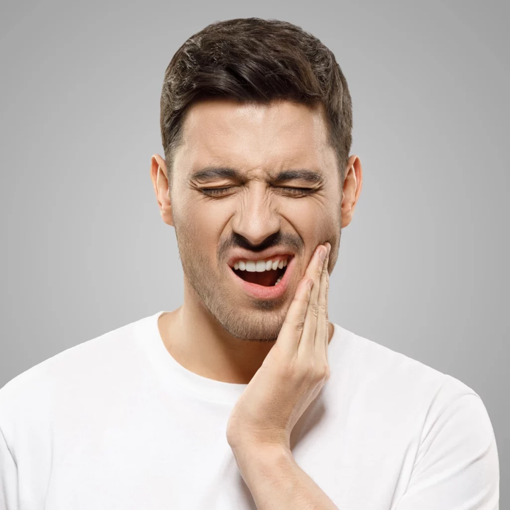 man rubbing jaw in pain and needs tmd treatment